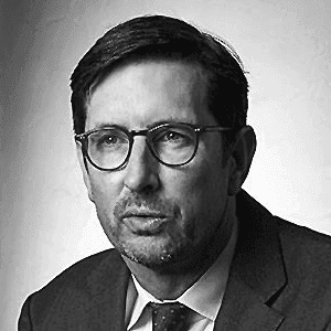 A black and white photo of a man in a suit and tie