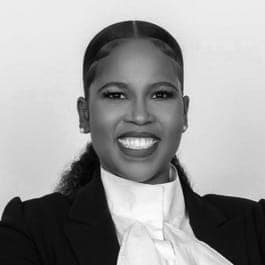 A black and white photo of a woman in a suit