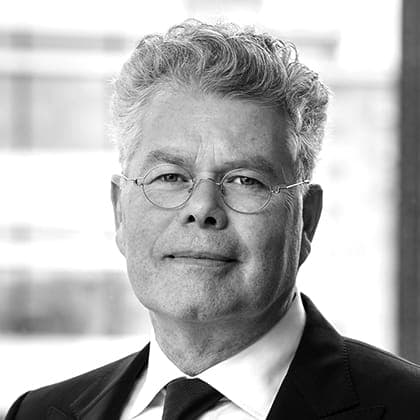 A black and white photo of a man in a suit and tie