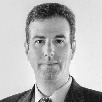 A black and white photo of a man in a suit and tie