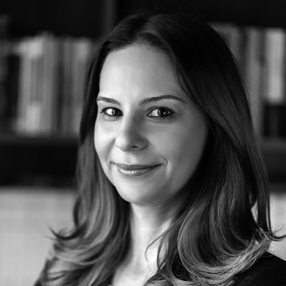 A black and white photo of a woman smiling