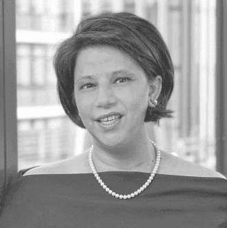 A black and white photo of a woman wearing a necklace